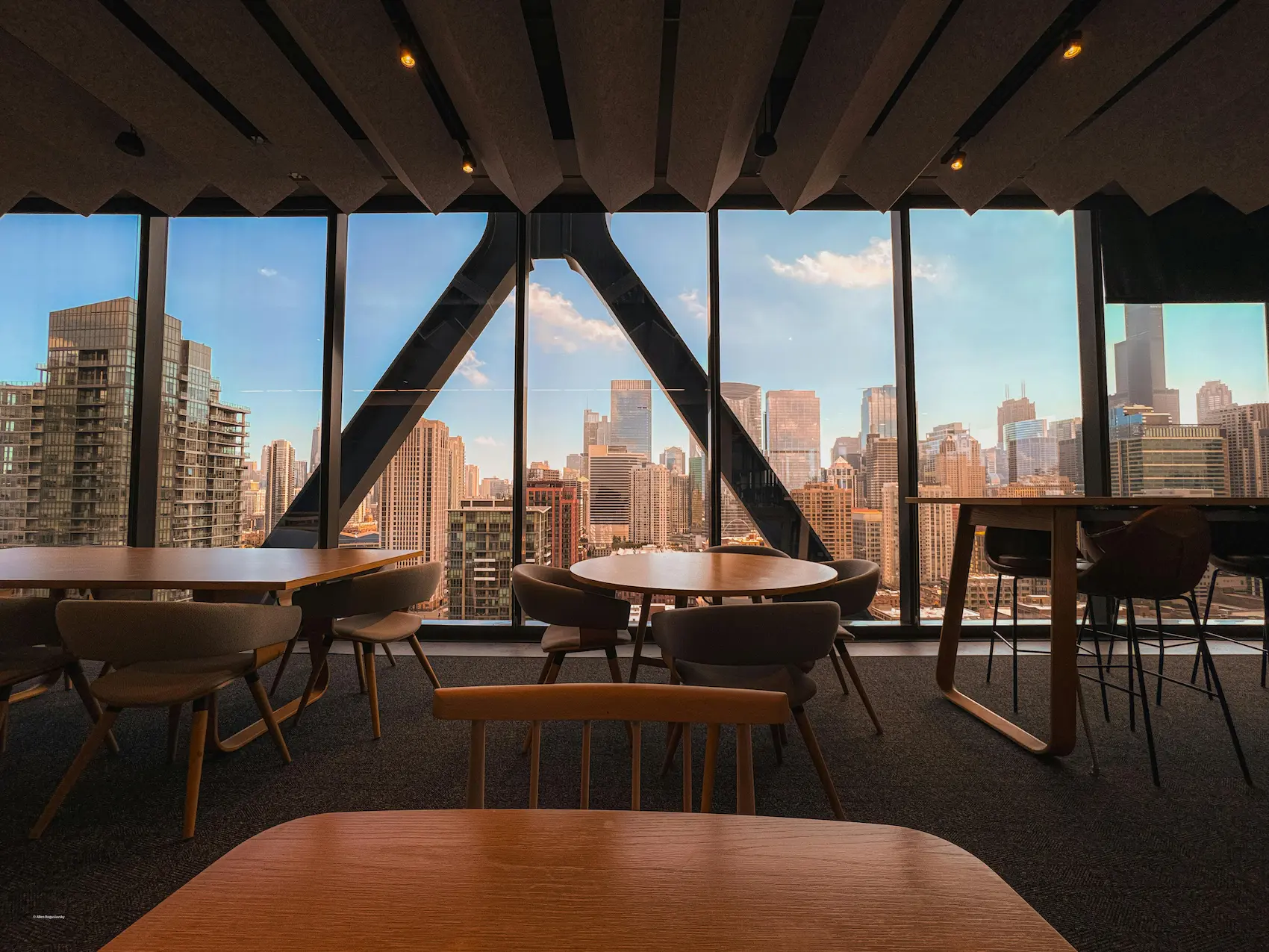 An empty modern lounge and meeting space overlooking a city skyline
